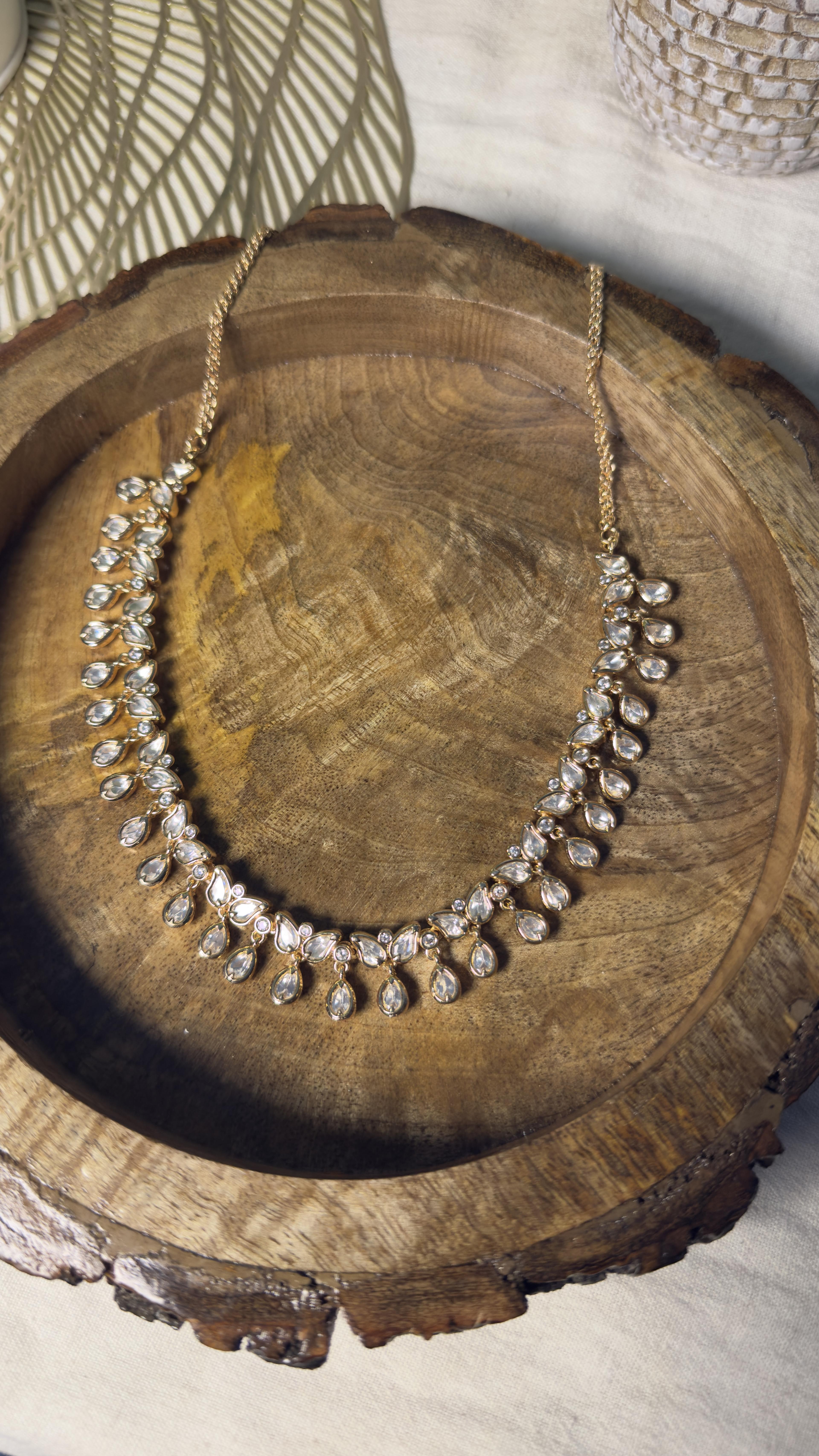Samridhi Teardrop Blossom Necklace on wooden platter