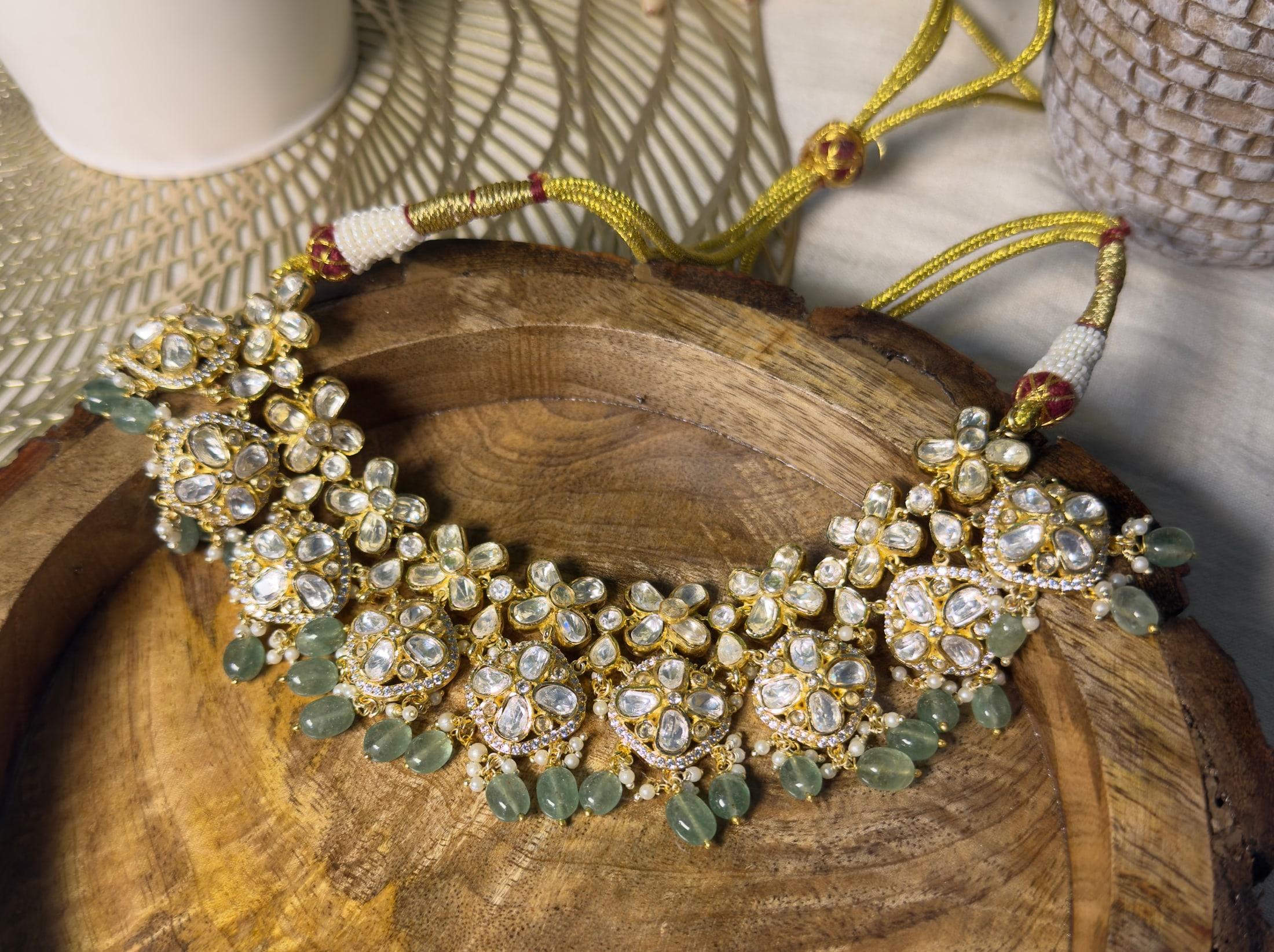 SHUBHADA Samridhi Collection statement necklace with woven pearl strands resting on a carved wooden platter